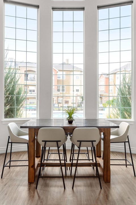 a clubhouse with a table and chairs in front of a window