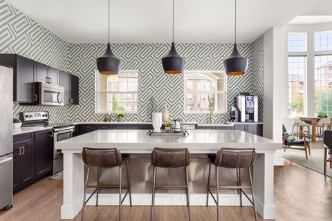 a clubhouse with a large white island with four chairs