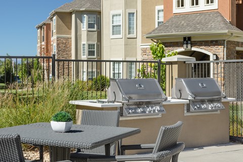 two grills with tables and chairs