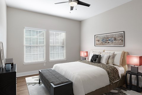 a bedroom with a large bed and a ceiling fan