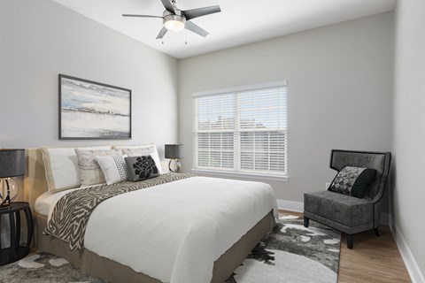 a bedroom with a large bed and a ceiling fan