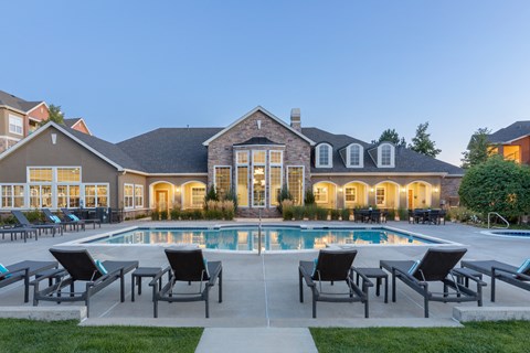 a swimming pool with chairs around