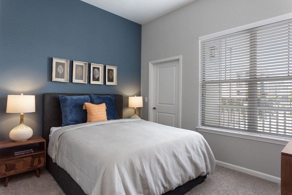 a bedroom with a large bed and a large window