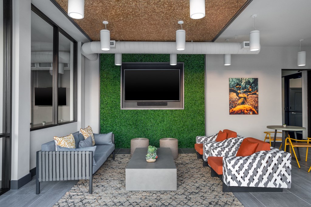 a living room with a green wall and a television