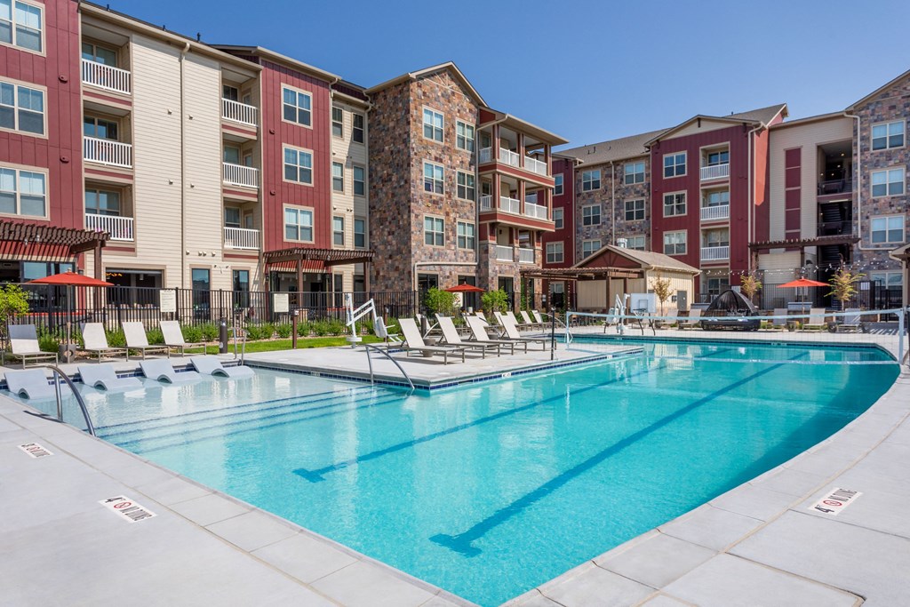 a swimming pool in front of an apartment building