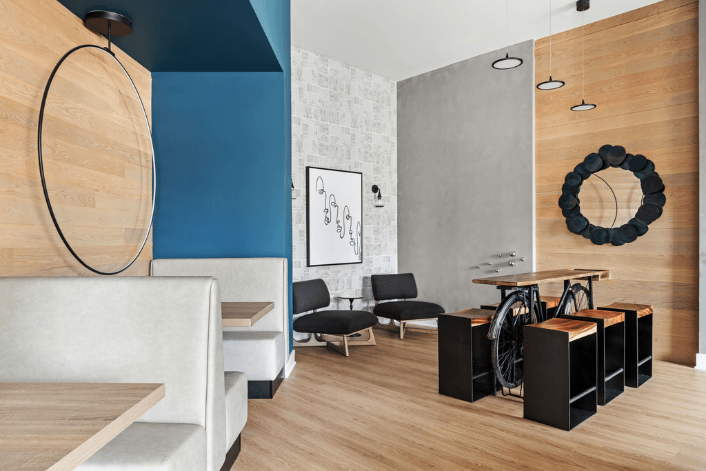 A modern living room with a white sofa and a wooden coffee table.