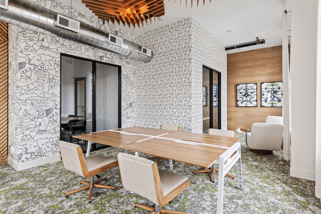 A conference room with a long table and chairs.