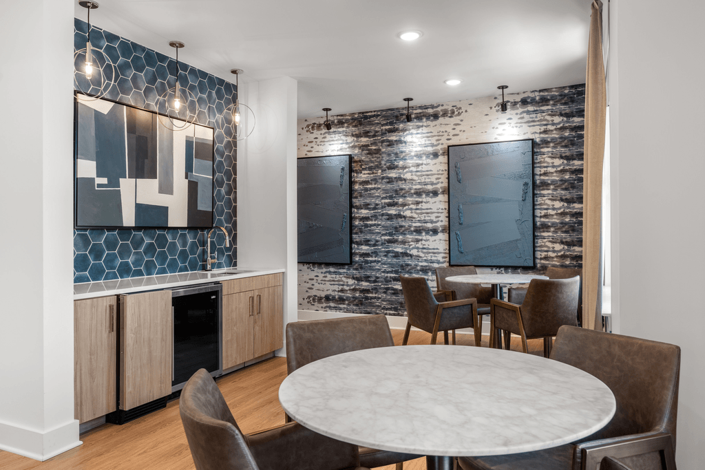 A modern dining room with a large table and chairs.