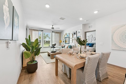 A dining room with a wooden table and chairs.