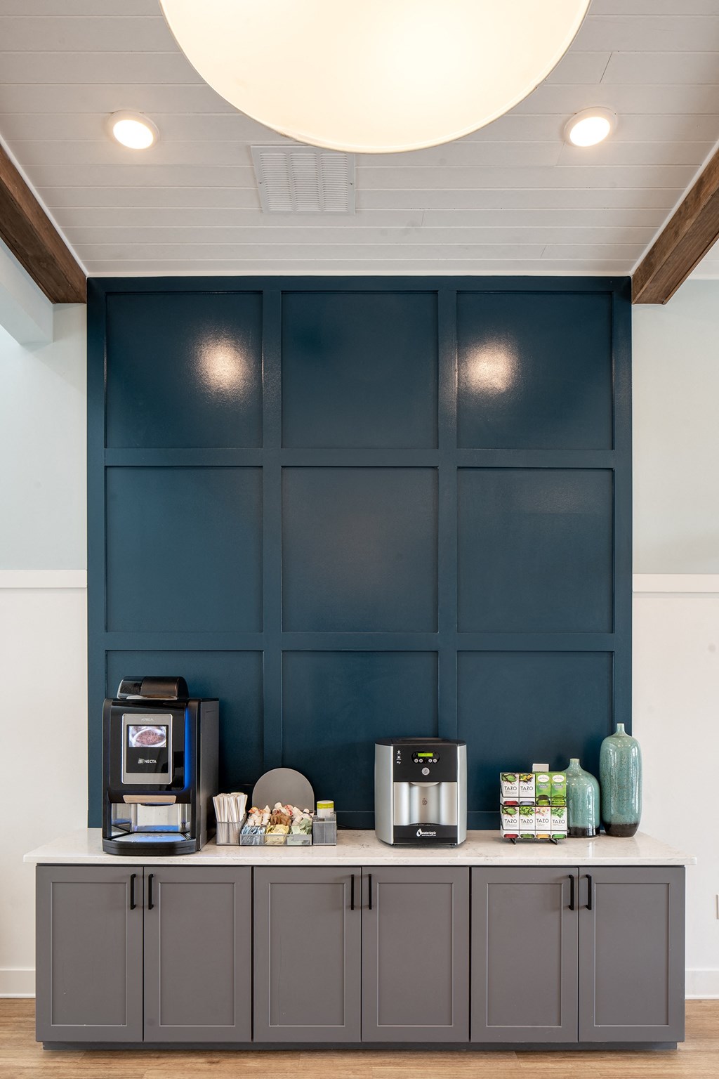 a coffee bar with two coffeemakers and two toaster ovens in front of a