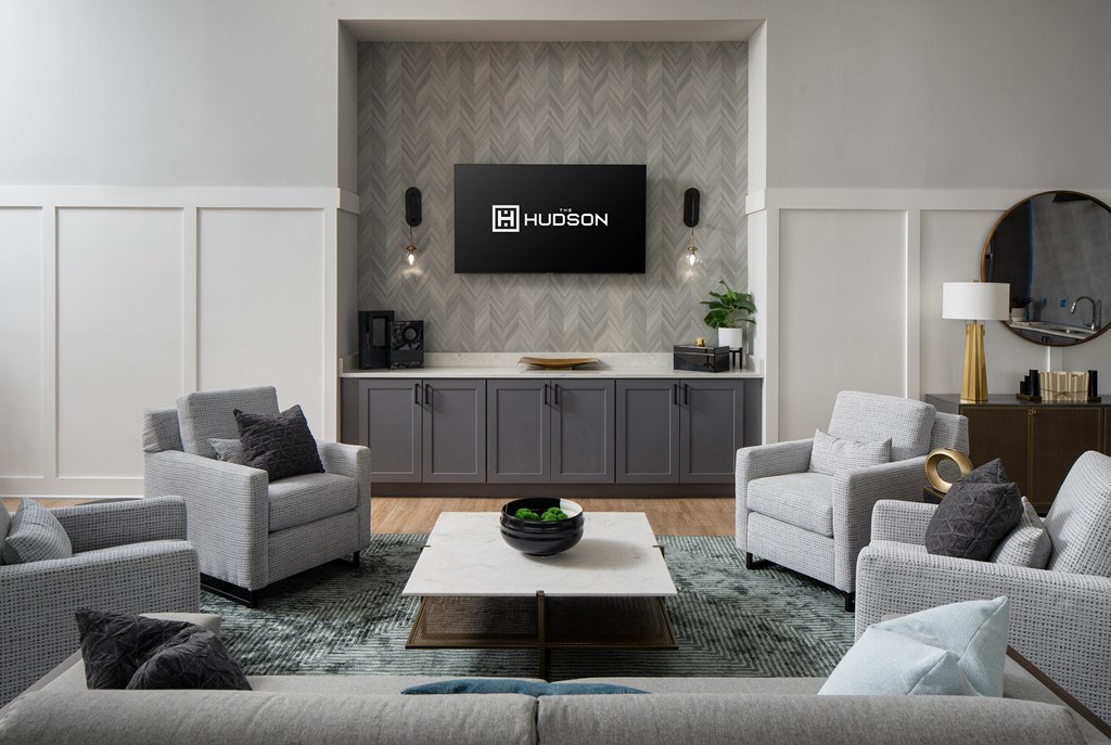 a living room filled with furniture and a flat screen tv