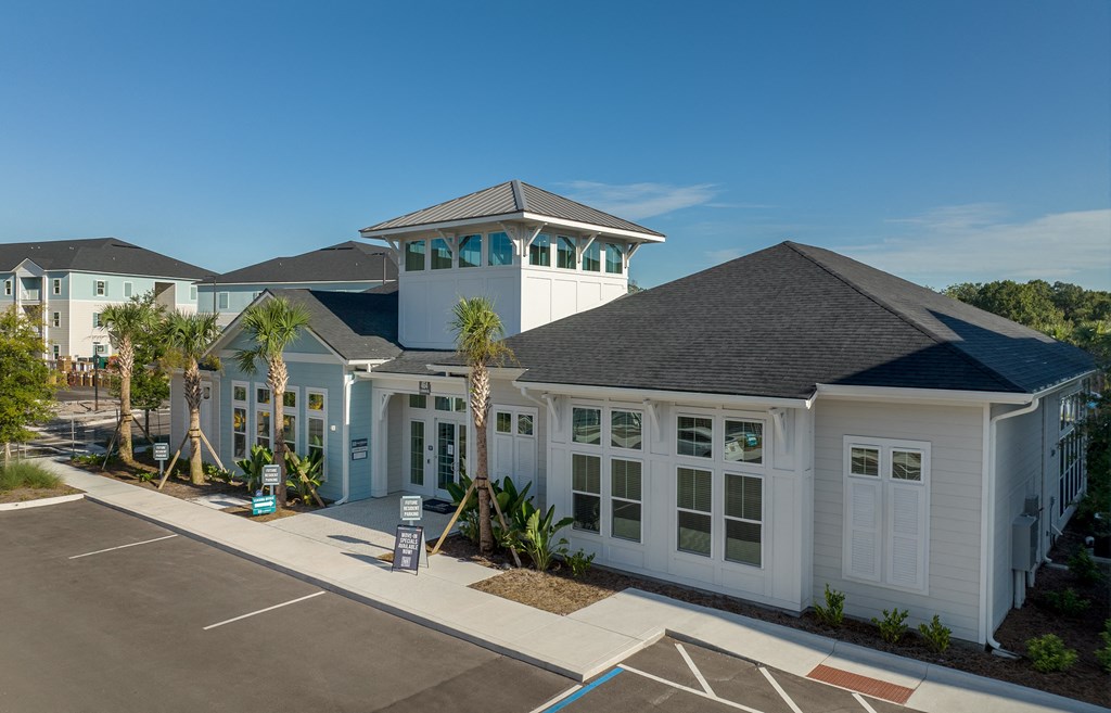 a building with a tower and a parking lot in front of it