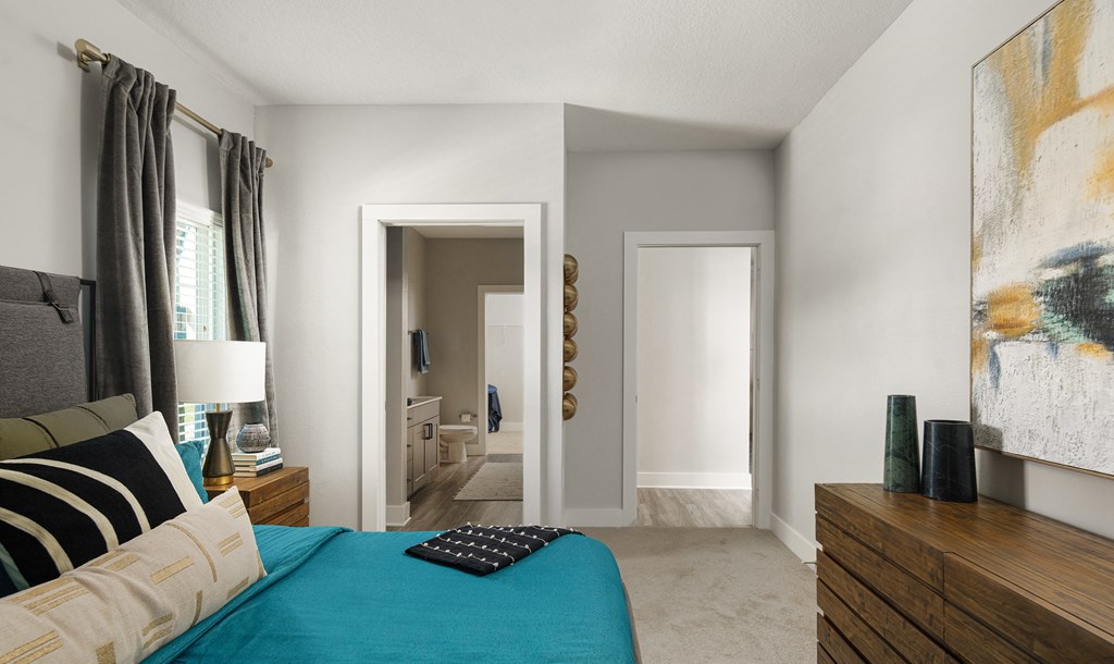 a bedroom with a bed and a dresser