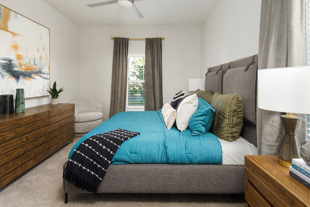 a bedroom with a bed and dresser