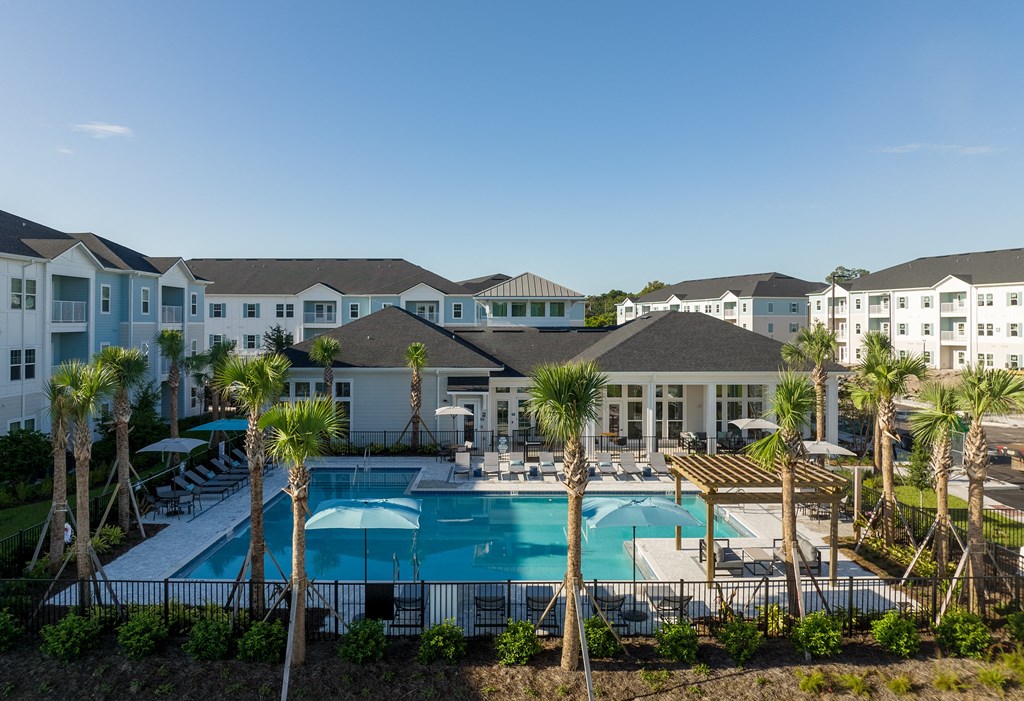 an aerial view of the resort style pool at the enclave at woodbridge apartments in sugar land