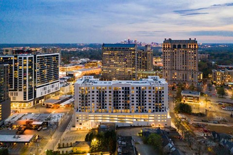 An aerial drone shot of the building from a far at sunset.