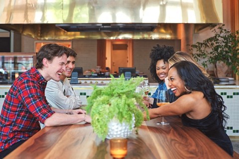A stock photo of people enjoying themselves at the table