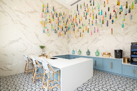 A lounge with a small table and a few chairs behind it