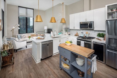 Kitchen with table and island showing the microwave and stove