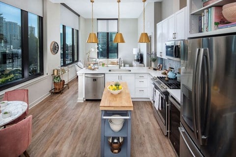 a kitchen with stainless steel appliances and a wooden table