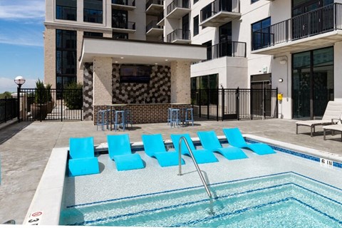 Pool photo with lounge chairs in the water