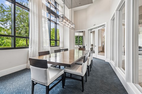 A dining room with a long table and chairs.