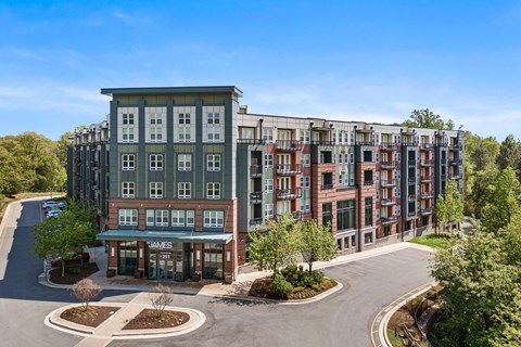 A large apartment complex with a roundabout in front.