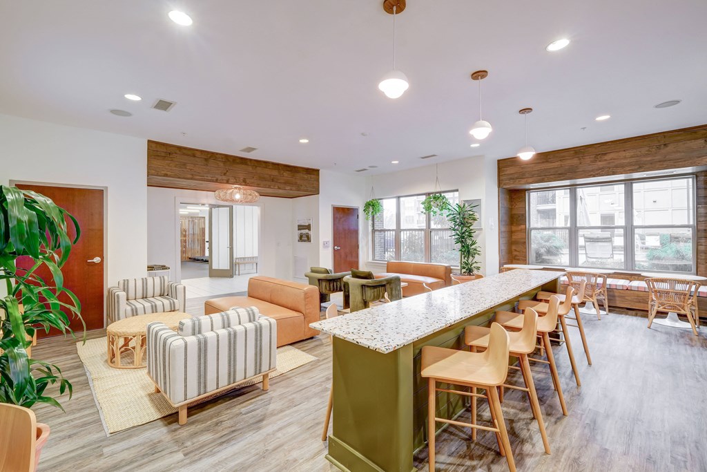 a communal area with couches chairs and a bar
