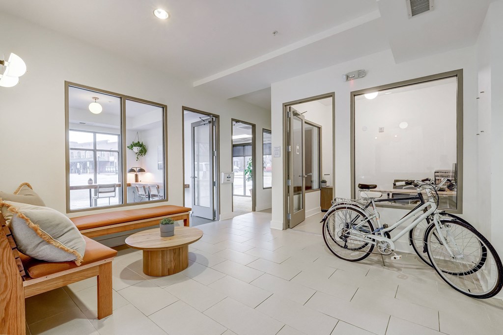 a bike is parked in a room with a bench and a table