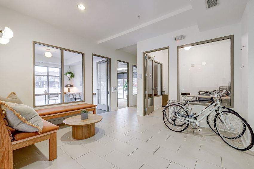 a bike is parked in a room with a bench and a table - Photo Gallery