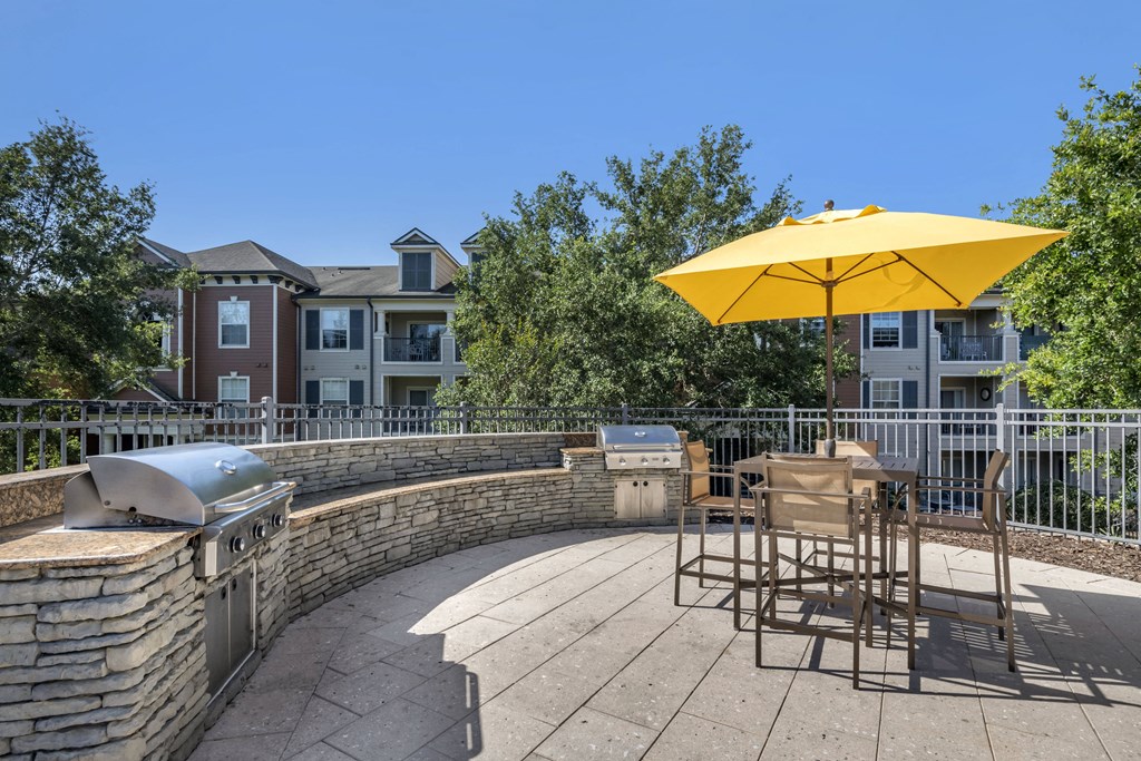 exterior clubhouse outdoor kitchen located by pool with seating