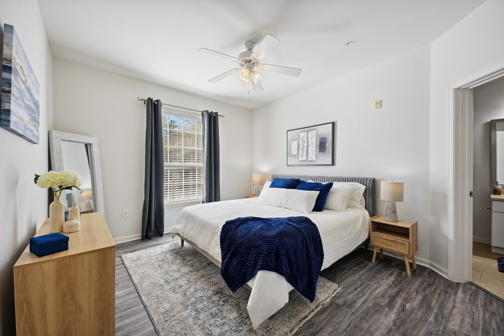 a bedroom with a large bed and a ceiling fan