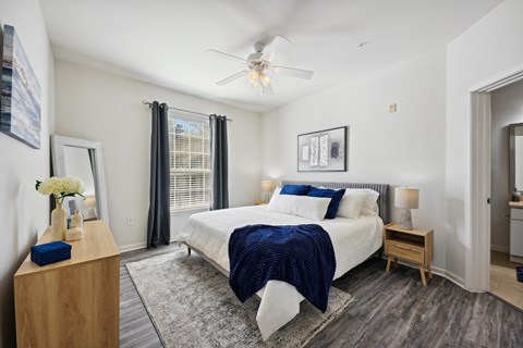 a bedroom with a large bed and a ceiling fan