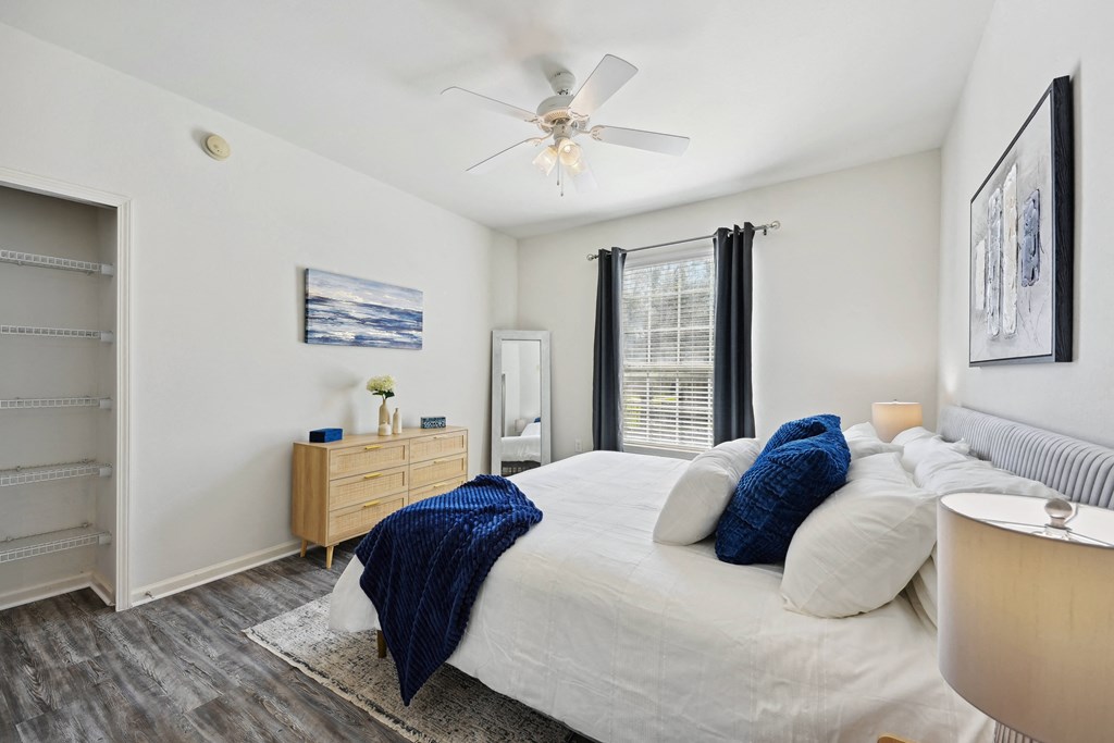 a bedroom with a large bed and a ceiling fan