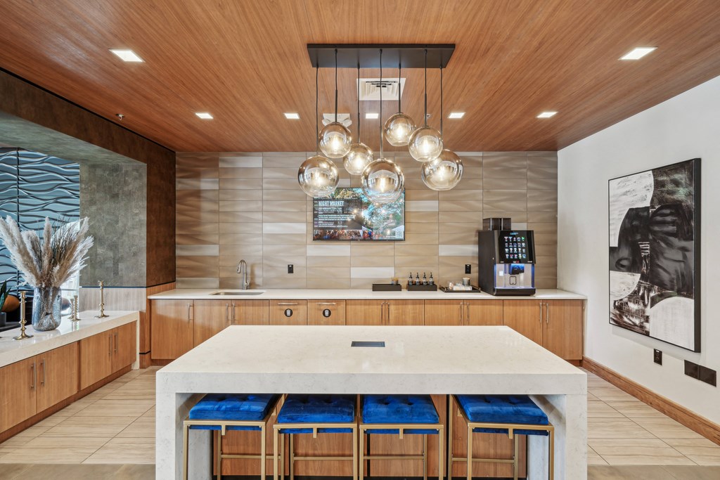 a large kitchen with a marble counter top and wooden cabinets