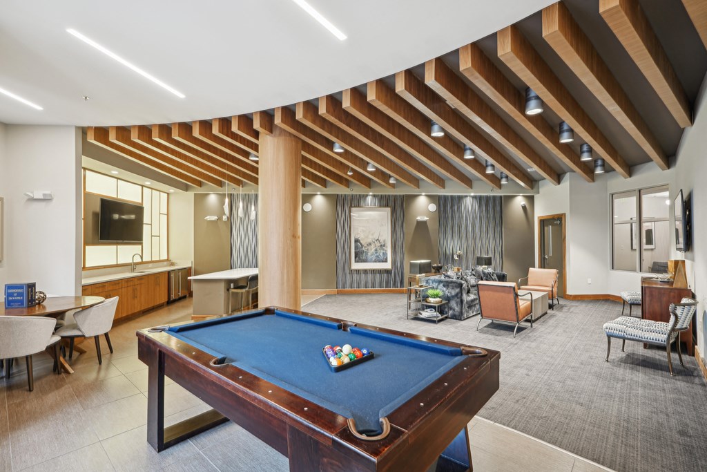 a clubhouse with a pool table and a living room