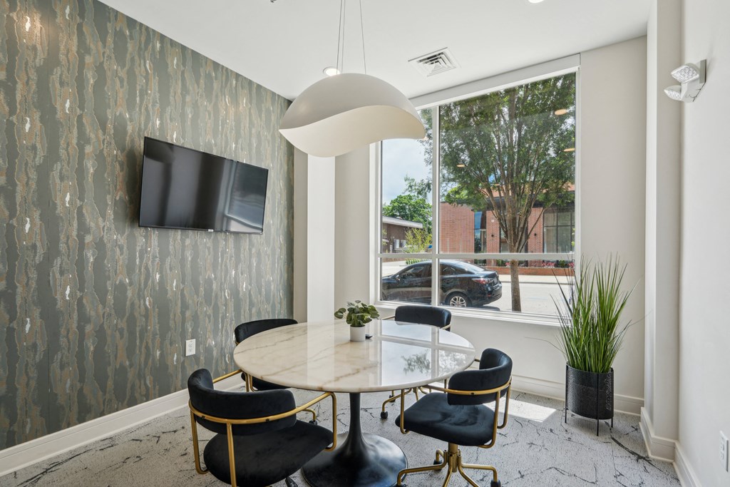 a dining room with a large window and a table and chairs