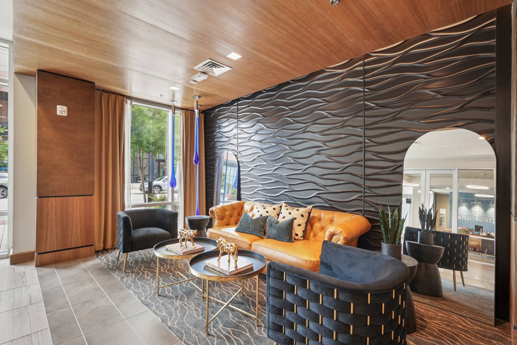 the lobby of a hotel with a couch and tables
