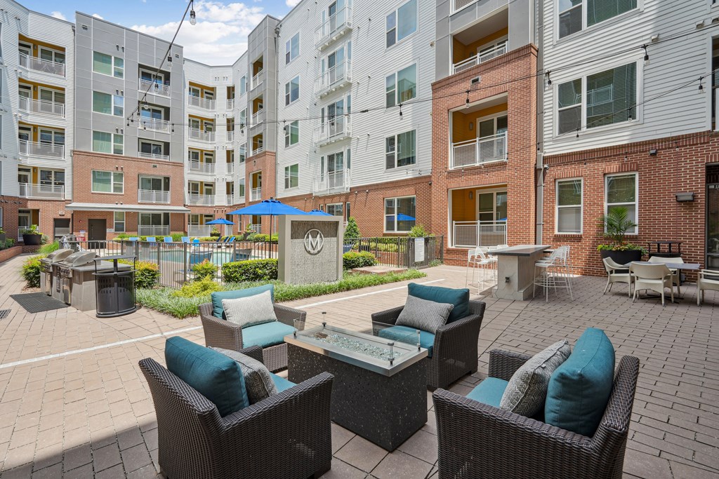 an outdoor patio with furniture and an apartment building