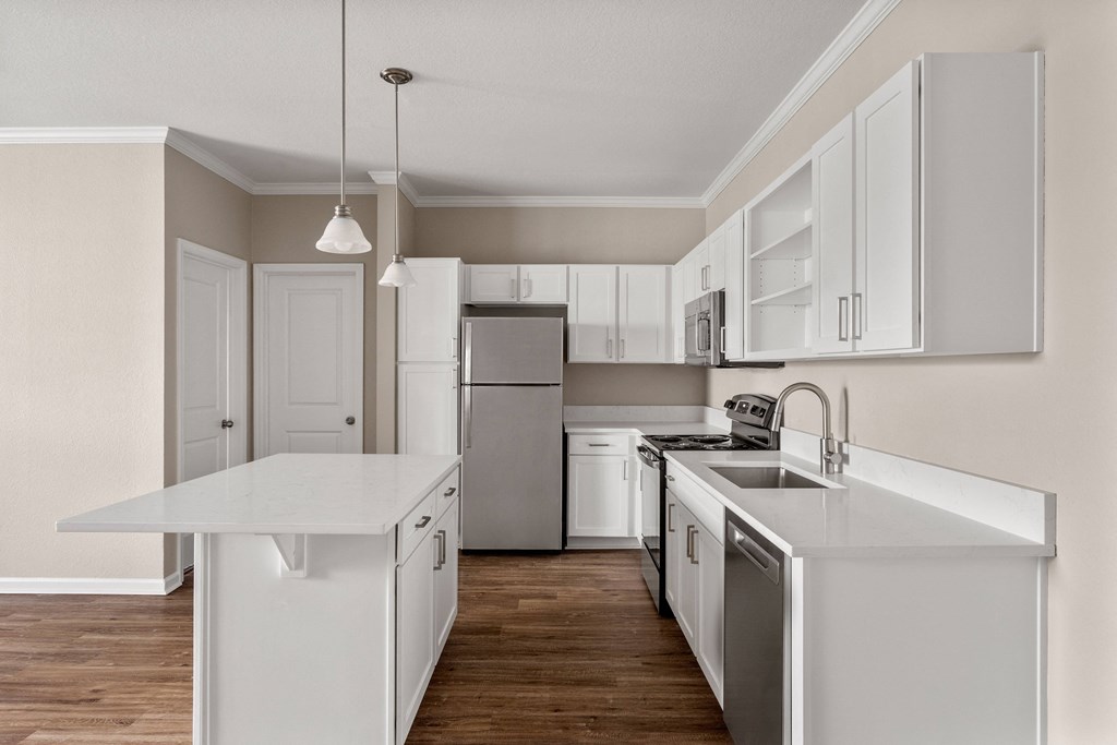 an expansive kitchen with white cabinets and stainless steel appliances