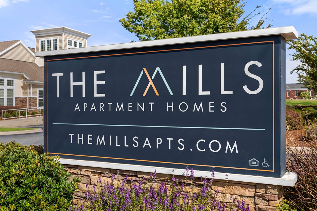 the apartments sign at the mills apartments apartment homes entrance sign