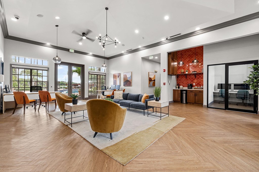 A modern room with a large rug in the center and seating around it.