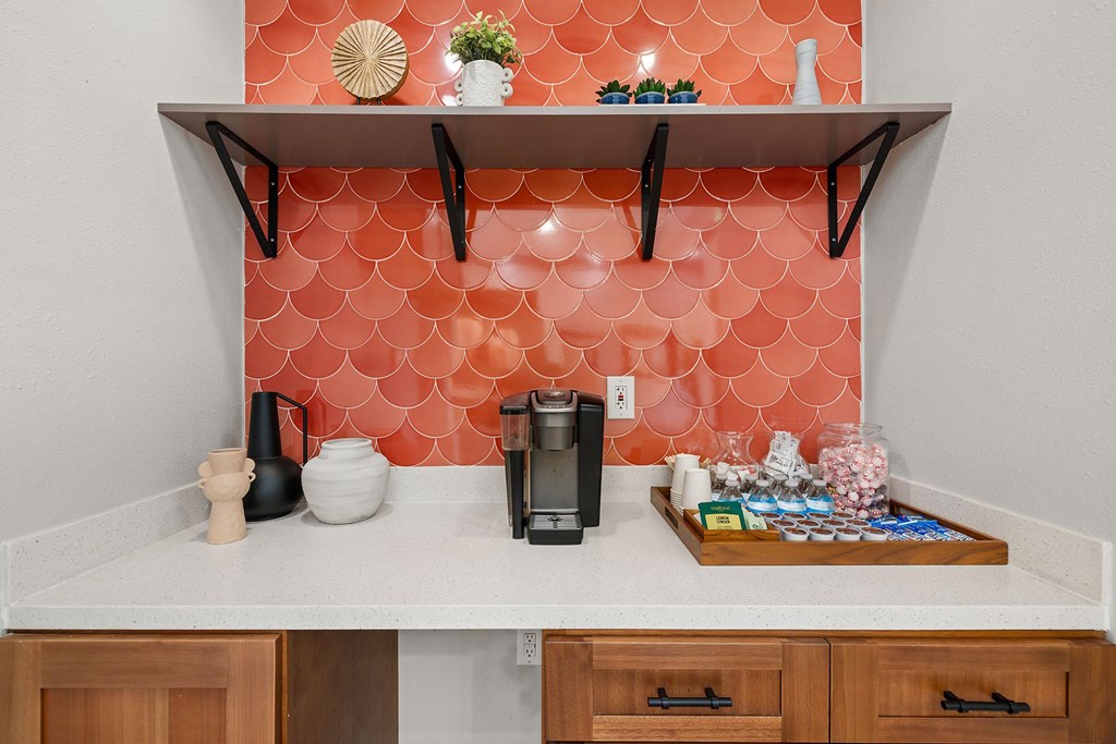 A counter with a coffee maker on a white counter.