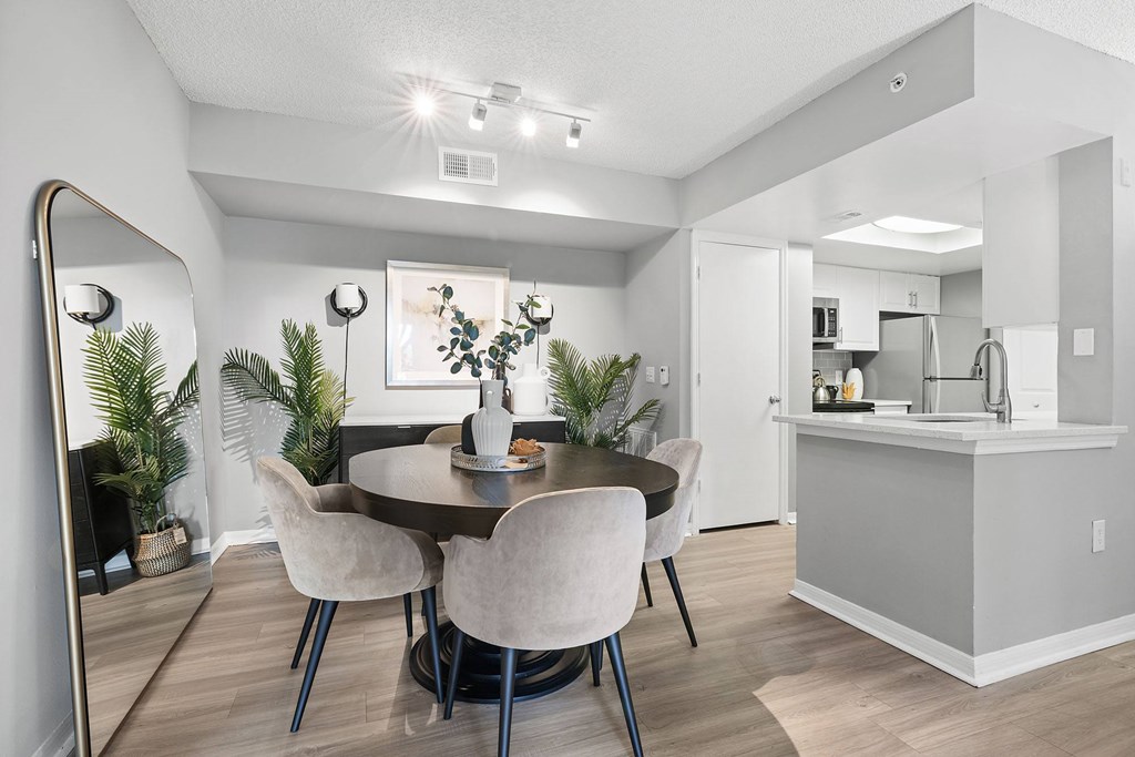 A dining room with a round table and chairs.