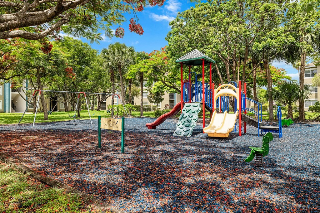 A playground with a slide, swings, and a climbing frame.
