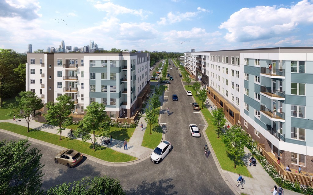 an aerial view of an urban street with buildings and cars