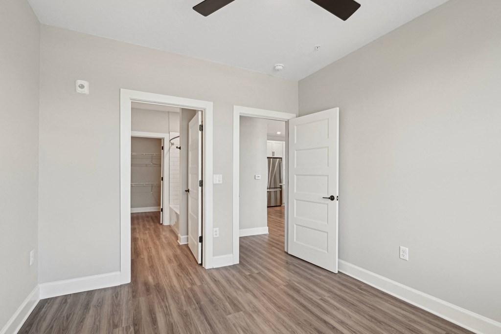 an empty living room with white walls and wood flooring
