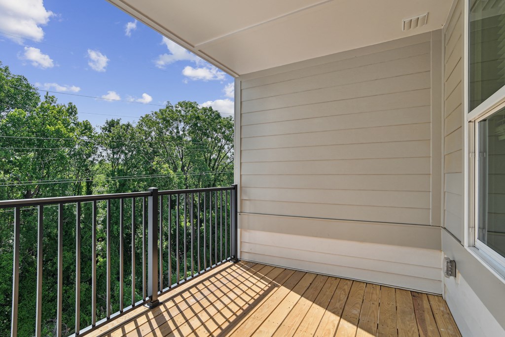 the retreat at thousand oaks balcony with wood flooring and railings and trees