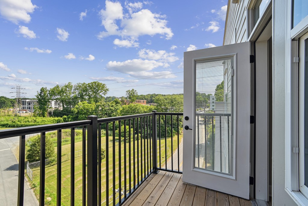 the view from the balcony of a home with a glass door and a balcony railing