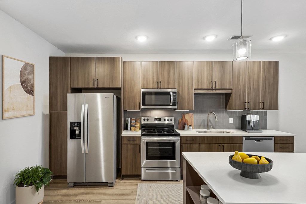 a kitchen with stainless steel appliances and wooden cabinets